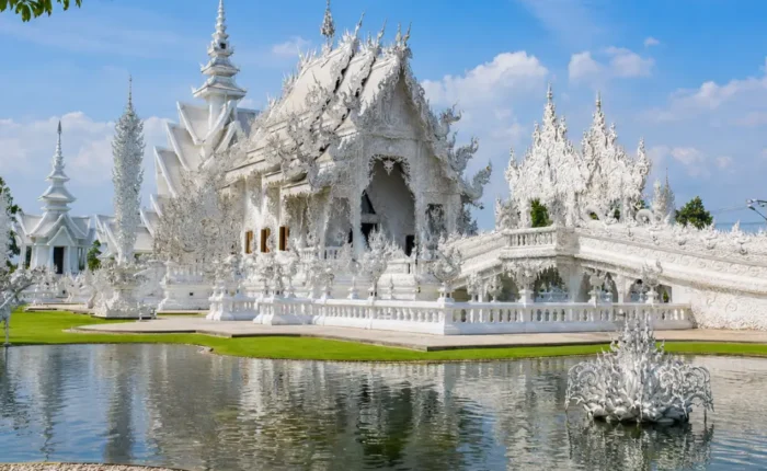 Chiang Rai Thailand with White Temple, ornate Thai architecture, lush gardens, and bright morning cultural atmosphere.
