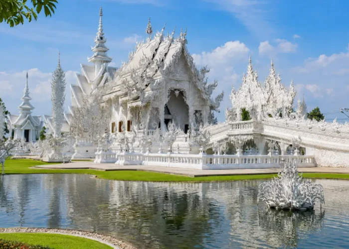Chiang Rai Thailand with White Temple, ornate Thai architecture, lush gardens, and bright morning cultural atmosphere.
