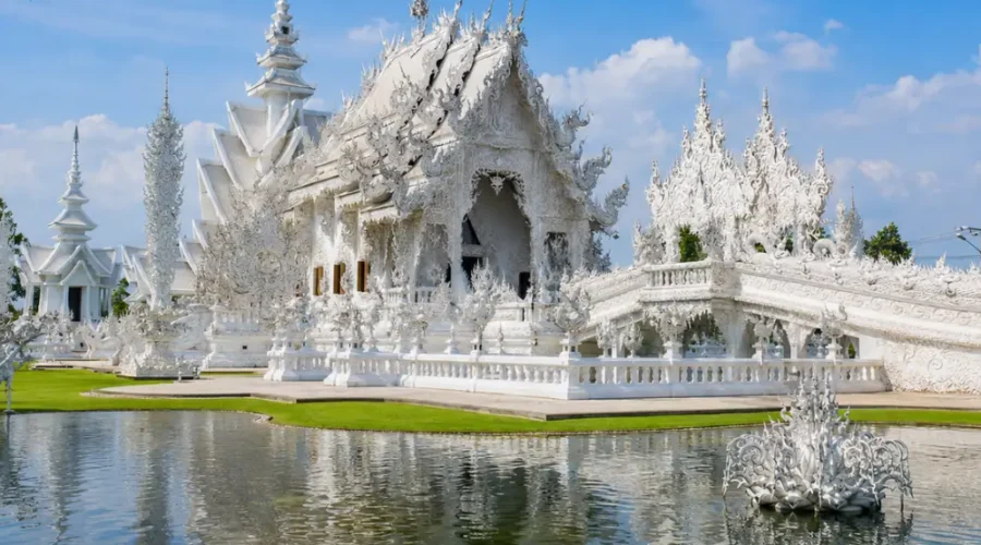 Chiang Rai Thailand with White Temple, ornate Thai architecture, lush gardens, and bright morning cultural atmosphere.