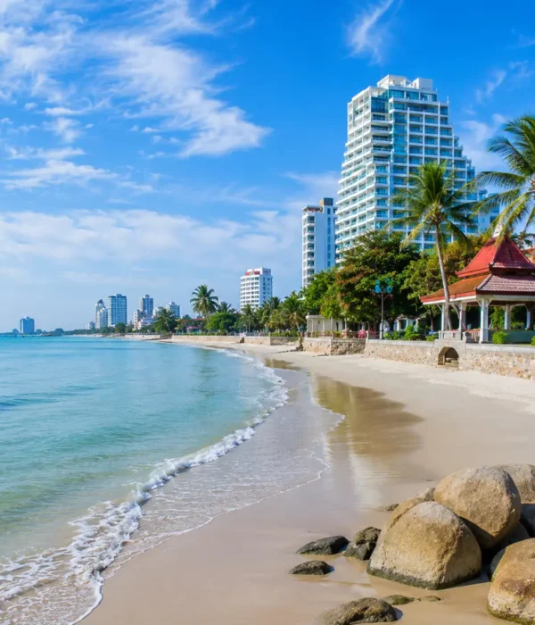 Hua Hin Beach Thailand with calm blue sea, soft sandy shore, luxury resorts, palm trees, and bright morning atmosphere.