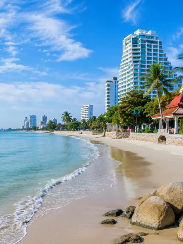 Hua Hin Beach Thailand with calm blue sea, soft sandy shore, luxury resorts, palm trees, and bright morning atmosphere.