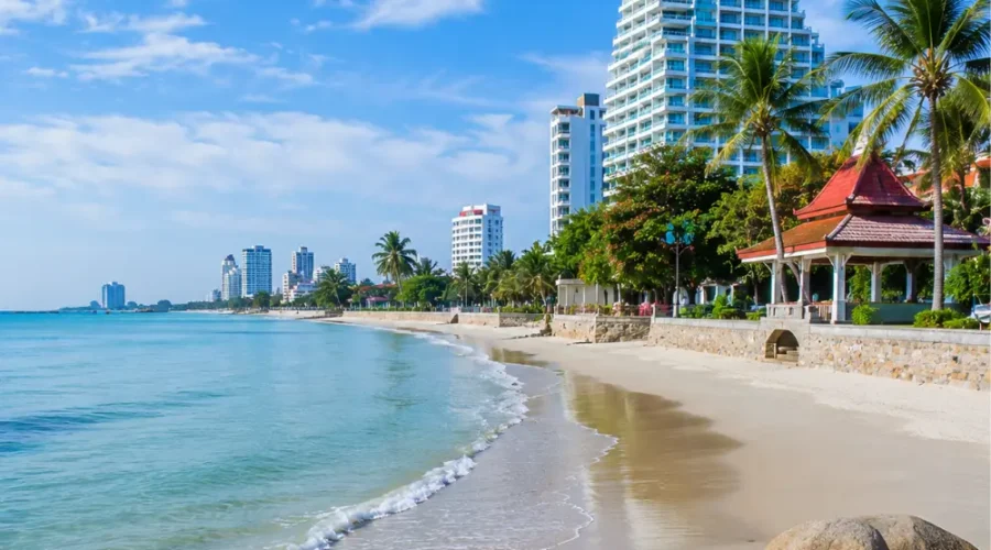 Hua Hin Beach Thailand with calm blue sea, soft sandy shore, luxury resorts, palm trees, and bright morning atmosphere.