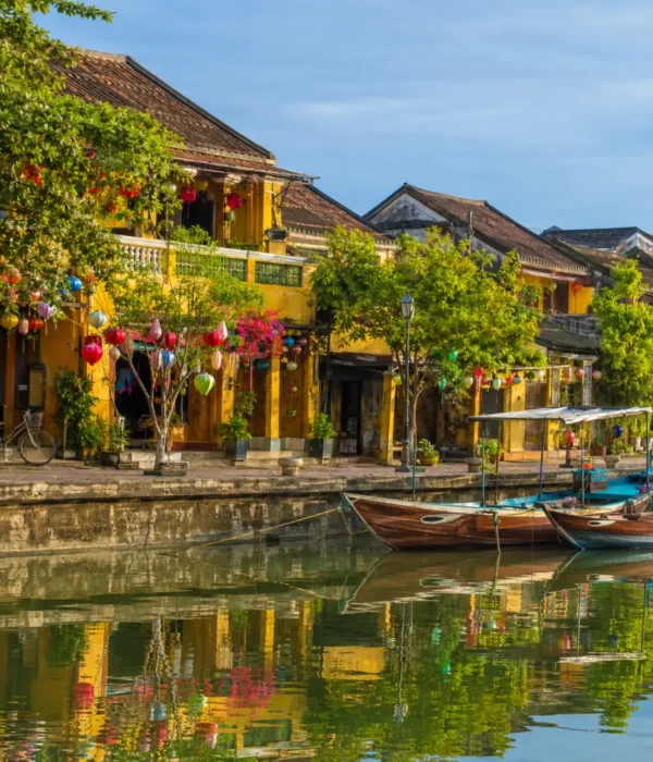 Hoi An Vietnam ancient town with lantern-lit streets, yellow heritage houses, and a premium cultural travel atmosphere.