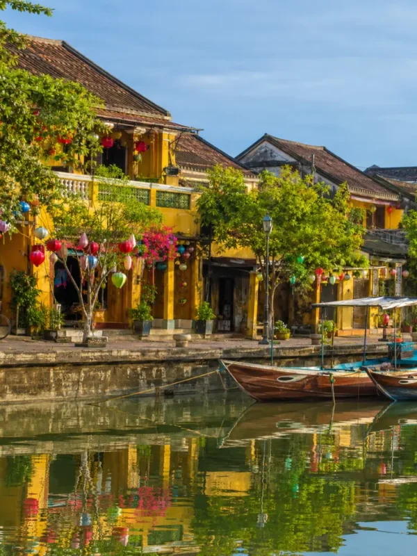 Hoi An Vietnam ancient town with lantern-lit streets, yellow heritage houses, and a premium cultural travel atmosphere.