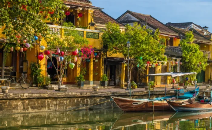 Hoi An Vietnam ancient town with lantern-lit streets, yellow heritage houses, and a premium cultural travel atmosphere.