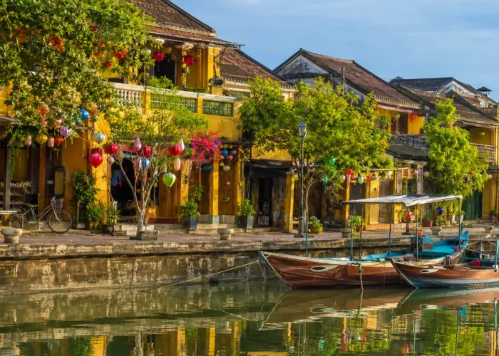Hoi An Vietnam ancient town with lantern-lit streets, yellow heritage houses, and a premium cultural travel atmosphere.