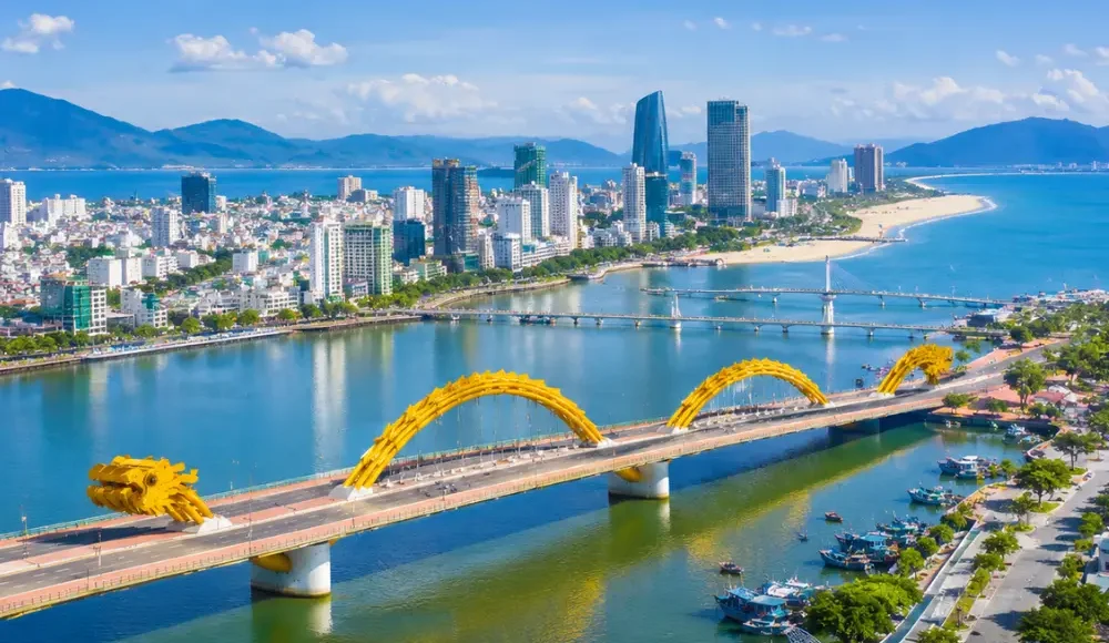 Da Nang Vietnam with Golden Bridge, lush Ba Na Hills scenery, and a bright premium luxury travel atmosphere.