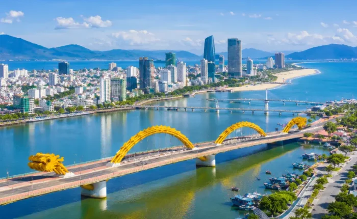 Da Nang Vietnam with Golden Bridge, lush Ba Na Hills scenery, and a bright premium luxury travel atmosphere.