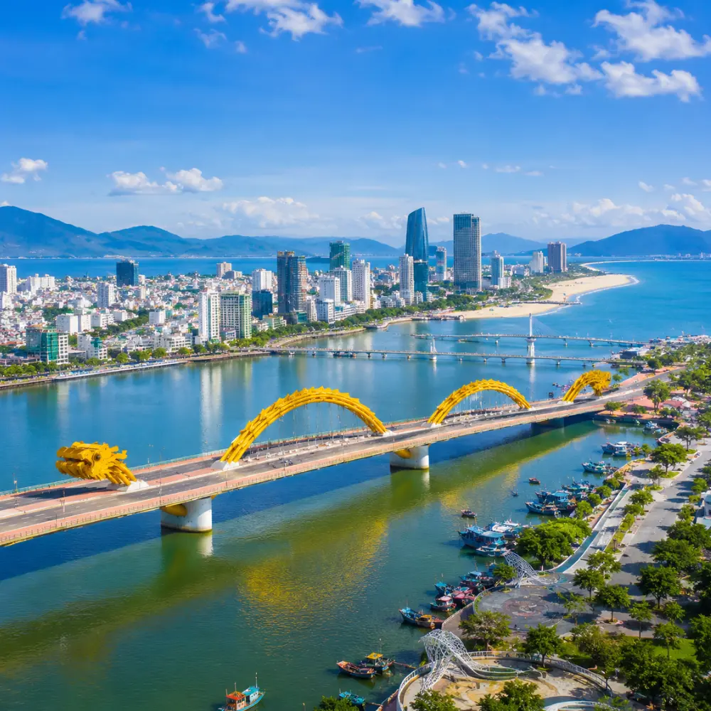 Da Nang Vietnam with Golden Bridge, lush Ba Na Hills scenery, and a bright premium luxury travel atmosphere.