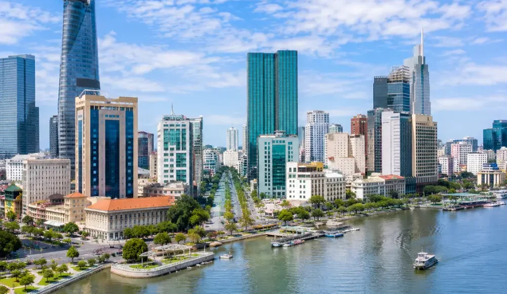 Ho Chi Minh City Vietnam skyline with modern towers, Saigon River views, and a premium urban travel atmosphere.