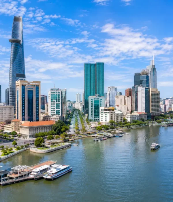 Ho Chi Minh City Vietnam skyline with modern towers, Saigon River views, and a premium urban travel atmosphere.