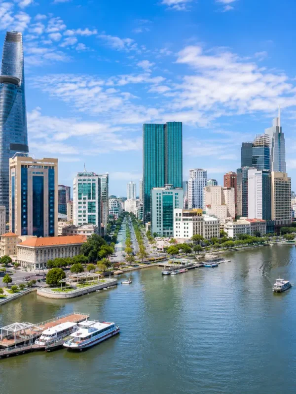Ho Chi Minh City Vietnam skyline with modern towers, Saigon River views, and a premium urban travel atmosphere.