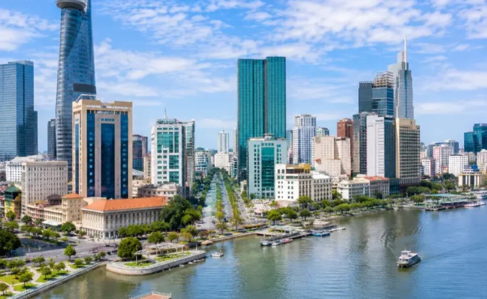Ho Chi Minh City Vietnam skyline with modern towers, Saigon River views, and a premium urban travel atmosphere.