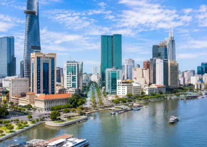 Ho Chi Minh City Vietnam skyline with modern towers, Saigon River views, and a premium urban travel atmosphere.