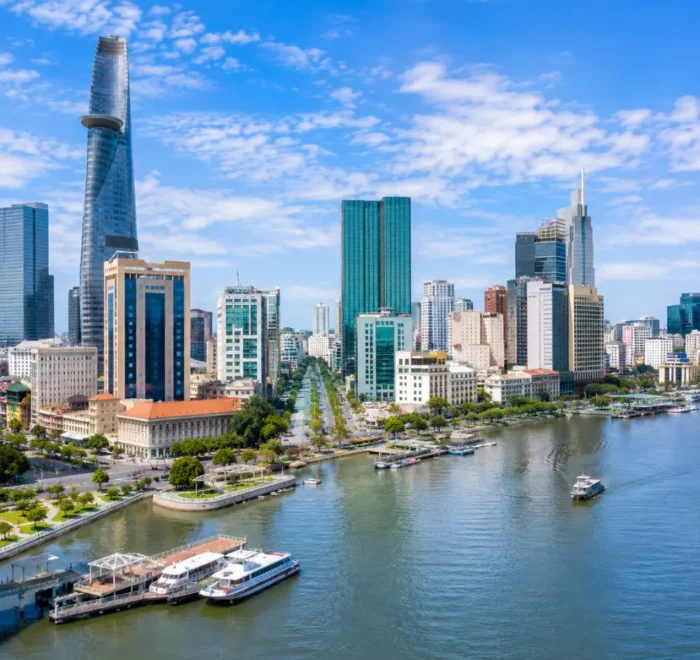 Ho Chi Minh City Vietnam skyline with modern towers, Saigon River views, and a premium urban travel atmosphere.
