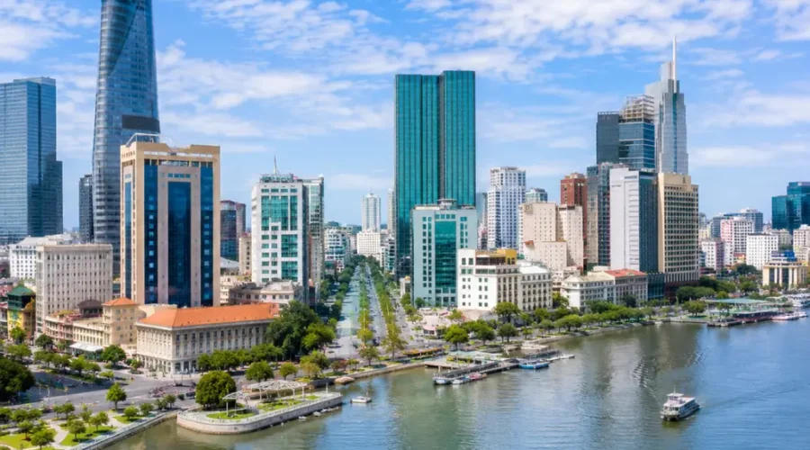 Ho Chi Minh City Vietnam skyline with modern towers, Saigon River views, and a premium urban travel atmosphere.