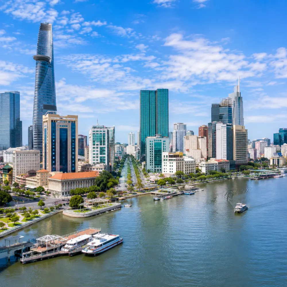Ho Chi Minh City Vietnam skyline with modern towers, Saigon River views, and a premium urban travel atmosphere.