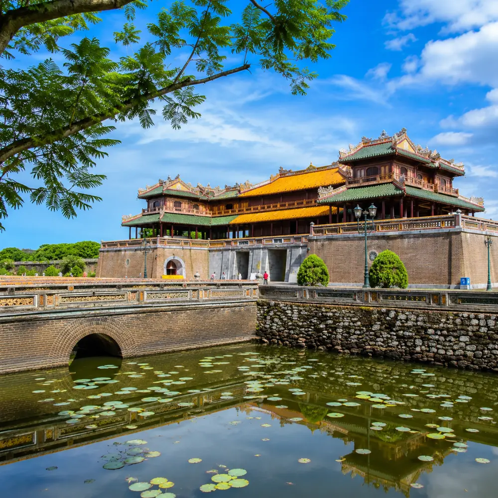 Hue Vietnam Imperial City with ancient royal architecture, lotus ponds, and a premium cultural travel atmosphere.