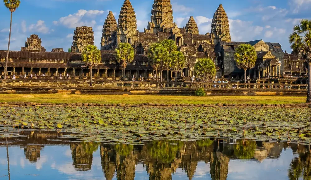 Siem Reap Cambodia with Angkor Wat temple, lotus ponds, ancient stone architecture, and a premium cultural travel atmosphere.