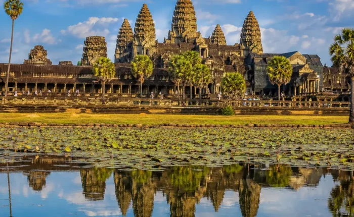 Siem Reap Cambodia with Angkor Wat temple, lotus ponds, ancient stone architecture, and a premium cultural travel atmosphere.