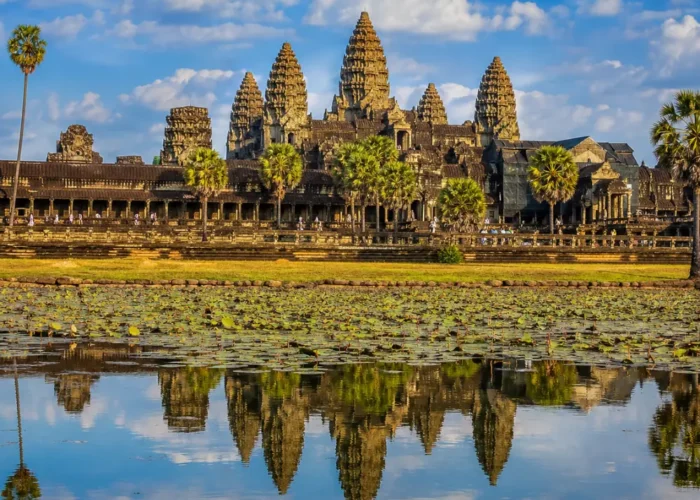 Siem Reap Cambodia with Angkor Wat temple, lotus ponds, ancient stone architecture, and a premium cultural travel atmosphere.