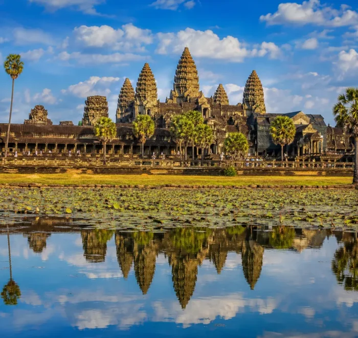 Siem Reap Cambodia with Angkor Wat temple, lotus ponds, ancient stone architecture, and a premium cultural travel atmosphere.