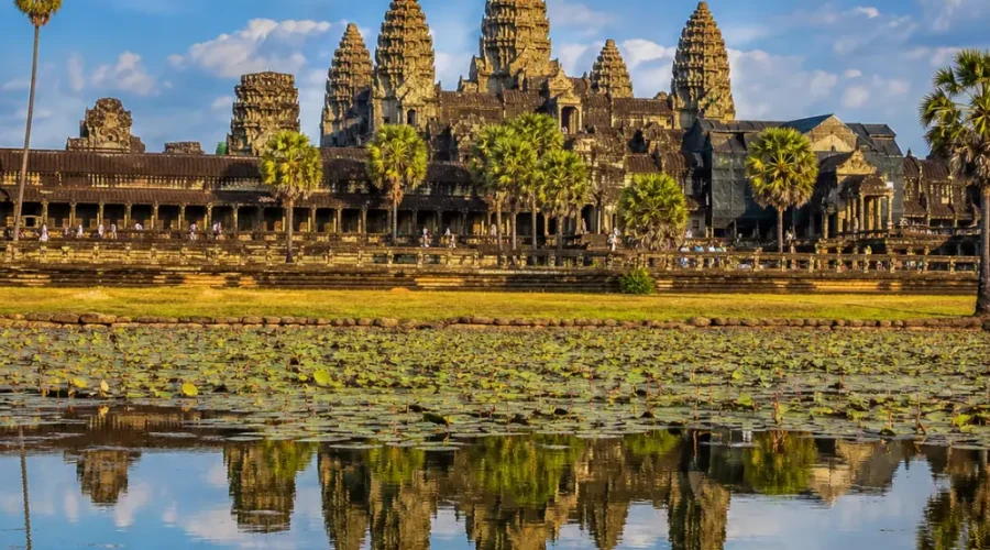 Siem Reap Cambodia with Angkor Wat temple, lotus ponds, ancient stone architecture, and a premium cultural travel atmosphere.