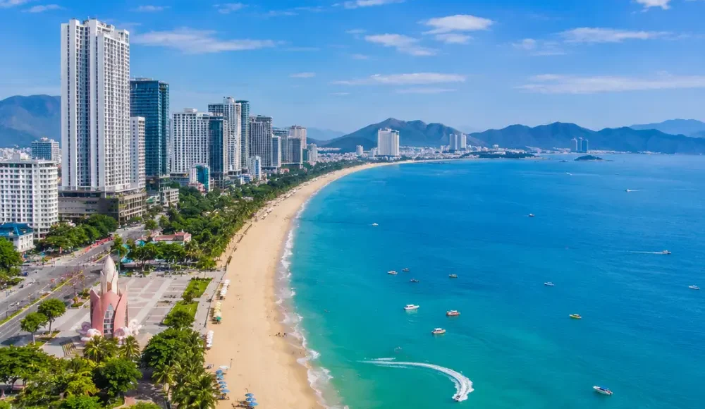 Nha Trang Vietnam beach with turquoise sea, modern coastline, tropical islands, and a premium luxury travel atmosphere