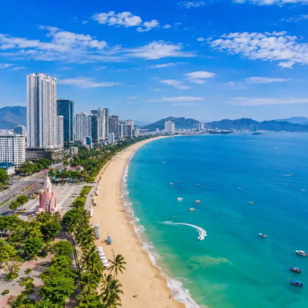 Nha Trang Vietnam beach with turquoise sea, modern coastline, tropical islands, and a premium luxury travel atmosphere