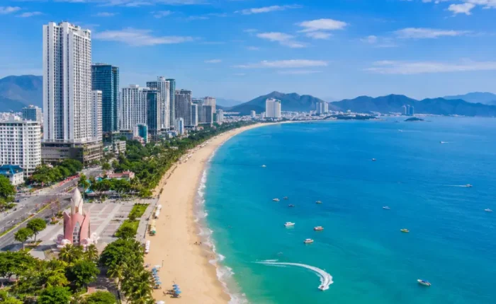 Nha Trang Vietnam beach with turquoise sea, modern coastline, tropical islands, and a premium luxury travel atmosphere