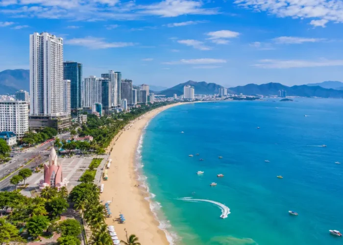 Nha Trang Vietnam beach with turquoise sea, modern coastline, tropical islands, and a premium luxury travel atmosphere