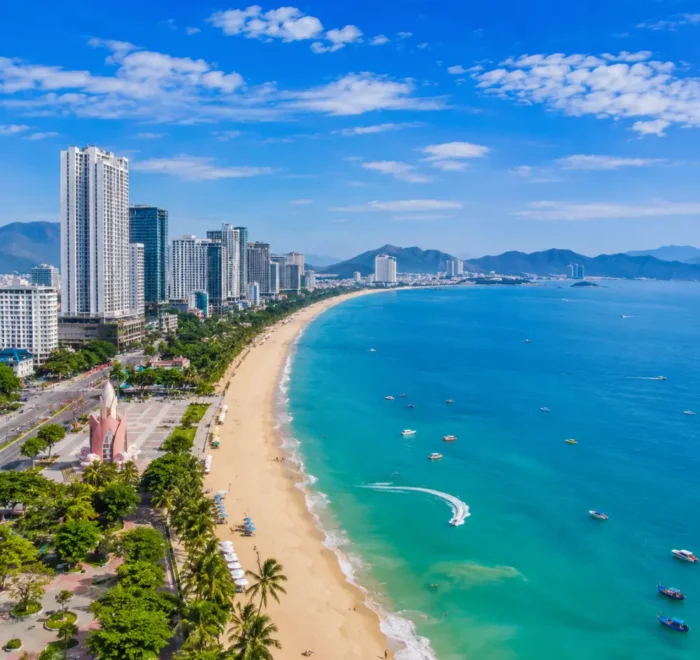 Nha Trang Vietnam beach with turquoise sea, modern coastline, tropical islands, and a premium luxury travel atmosphere