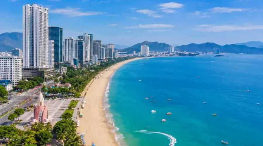 Nha Trang Vietnam beach with turquoise sea, modern coastline, tropical islands, and a premium luxury travel atmosphere