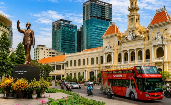 Ho Chi Minh City tour with City Hall, Ho Chi Minh statue, lotus garden, sightseeing bus, and modern Saigon skyline.