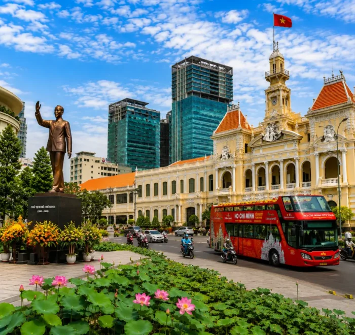 Ho Chi Minh City tour with City Hall, Ho Chi Minh statue, lotus garden, sightseeing bus, and modern Saigon skyline.