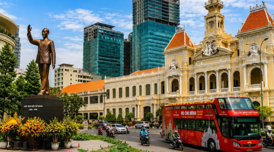 Ho Chi Minh City tour with City Hall, Ho Chi Minh statue, lotus garden, sightseeing bus, and modern Saigon skyline.