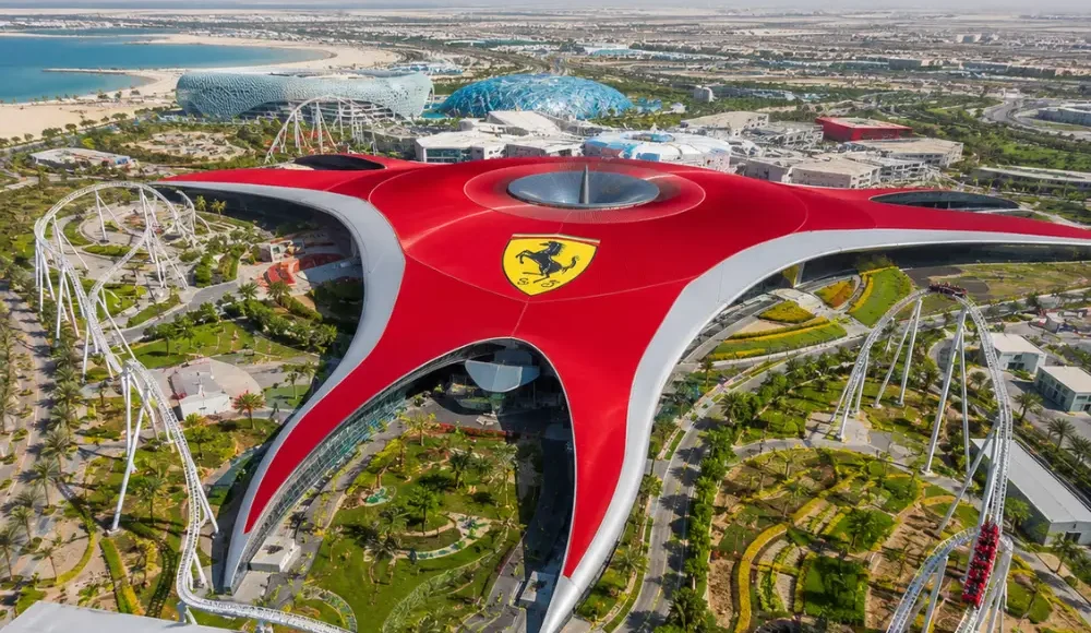 Yas Island Ferrari World Abu Dhabi with red Ferrari-inspired architecture, luxury theme park entrance, and premium UAE travel atmosphere.