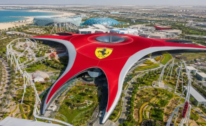 Yas Island Ferrari World Abu Dhabi with red Ferrari-inspired architecture, luxury theme park entrance, and premium UAE travel atmosphere.