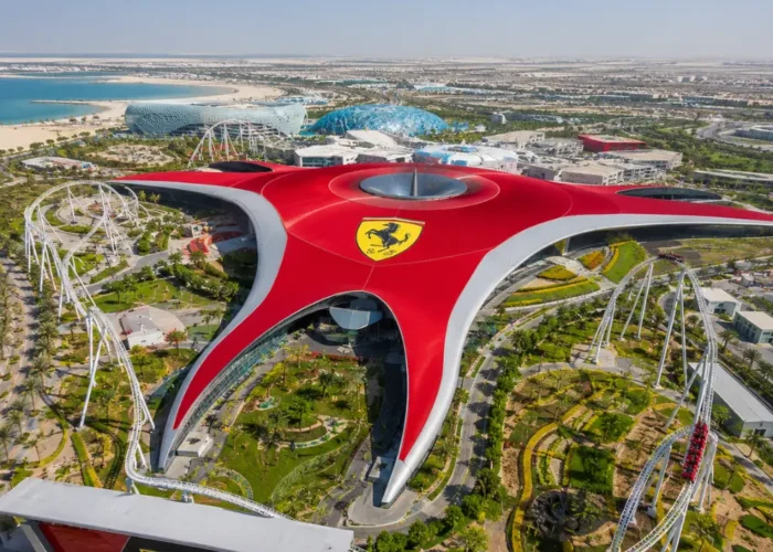 Yas Island Ferrari World Abu Dhabi with red Ferrari-inspired architecture, luxury theme park entrance, and premium UAE travel atmosphere.