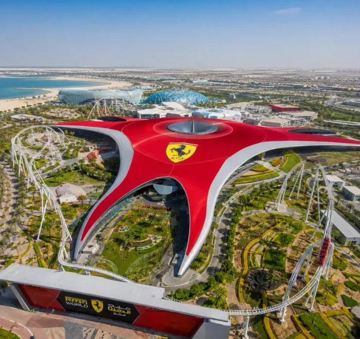 Yas Island Ferrari World Abu Dhabi with red Ferrari-inspired architecture, luxury theme park entrance, and premium UAE travel atmosphere.