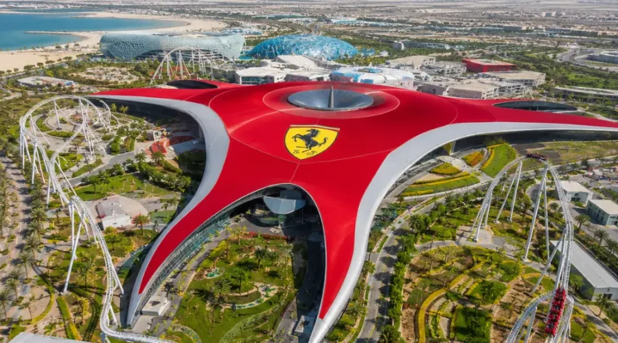 Yas Island Ferrari World Abu Dhabi with red Ferrari-inspired architecture, luxury theme park entrance, and premium UAE travel atmosphere.