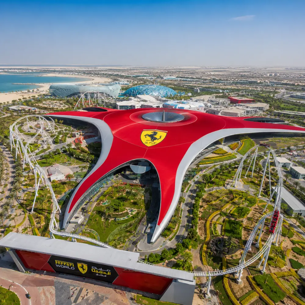 Yas Island Ferrari World Abu Dhabi with red Ferrari-inspired architecture, luxury theme park entrance, and premium UAE travel atmosphere.