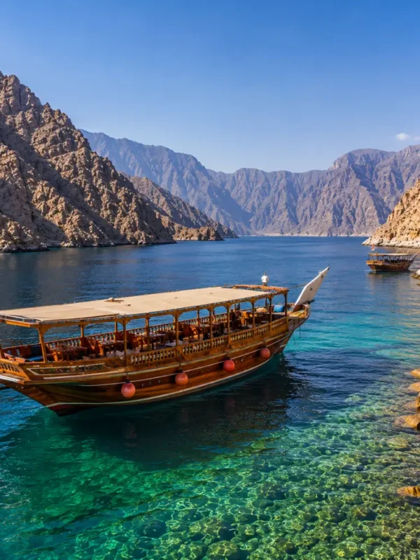 Oman Musandam cruise with traditional dhow boat, turquoise fjord waters, rocky cliffs, and a premium Arabian sea tour atmosphere.