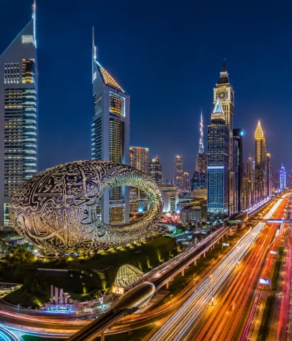 Dubai night skyline with Museum of the Future, glowing city lights, futuristic towers, and a premium luxury travel atmosphere.