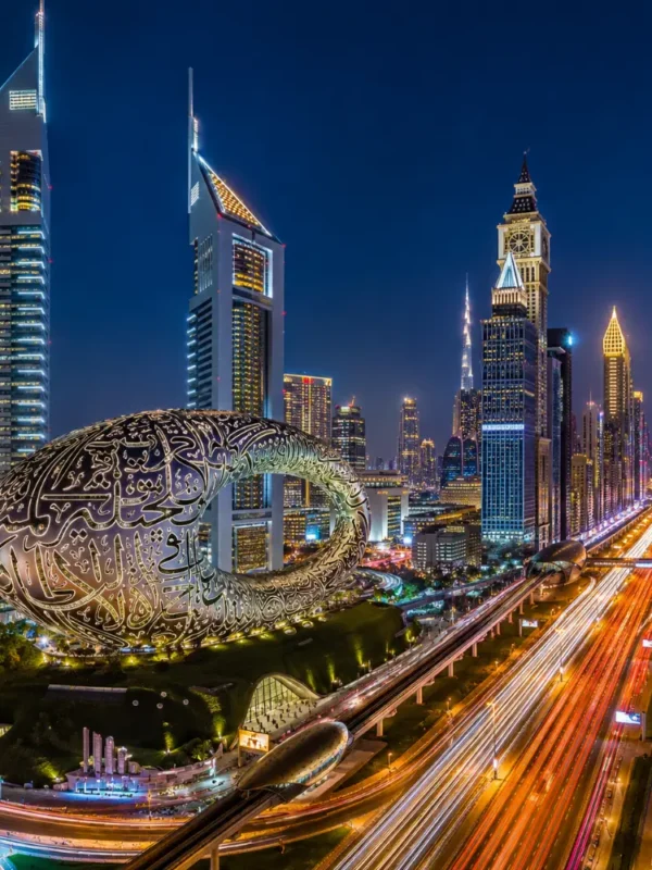 Dubai night skyline with Museum of the Future, glowing city lights, futuristic towers, and a premium luxury travel atmosphere.