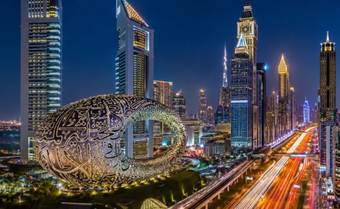 Dubai night skyline with Museum of the Future, glowing city lights, futuristic towers, and a premium luxury travel atmosphere.