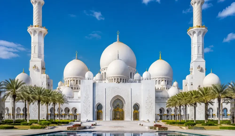 Sheikh Zayed Grand Mosque in Abu Dhabi with white marble domes, grand minarets, reflective pools, and a premium cultural travel atmosphere.