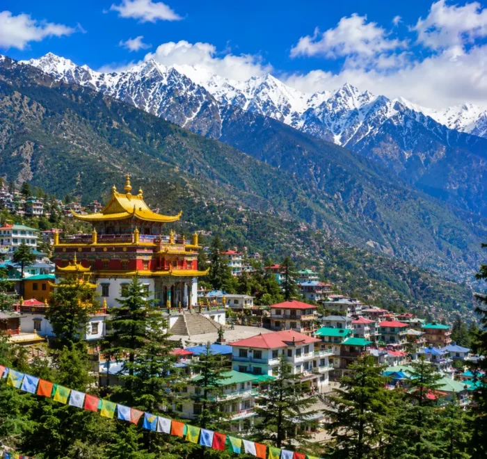 Dharamshala with Dhauladhar mountains, pine forests, Tibetan monastery and clear morning Himalayan views.