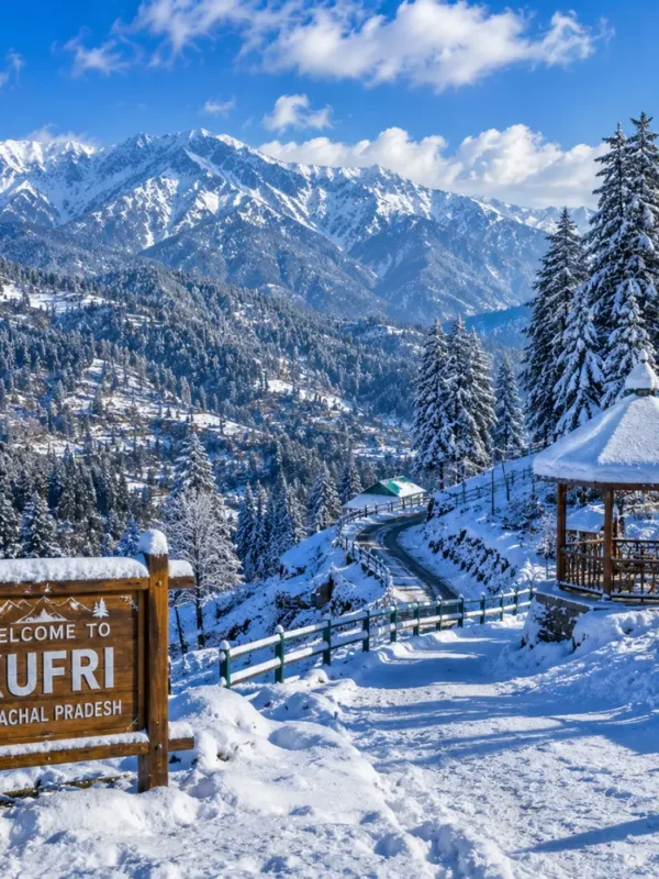 Kufri hill station with pine forests, snowy Himalayan views, green slopes and clear morning mountain scenery near Shimla.