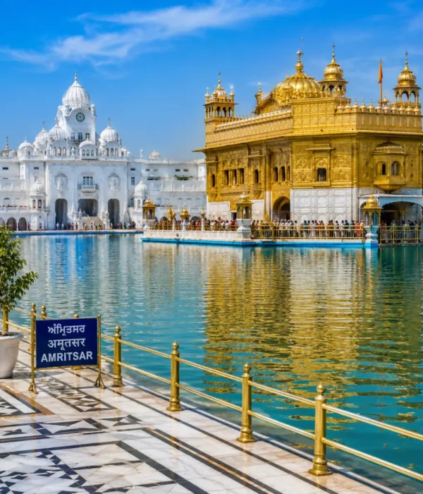 Amritsar Golden Temple with sacred pool reflections, Sikh architecture and clear morning daylight in Punjab.